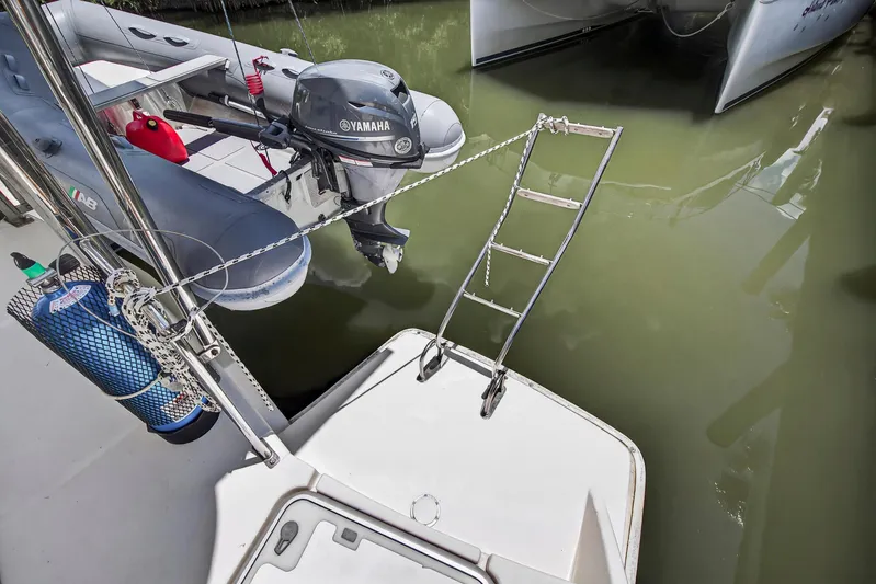 Cocoa Bella Yacht Photos Pics Leopard 38 catamaran with Yamaha motor and boarding ladder, docked in calm waters.