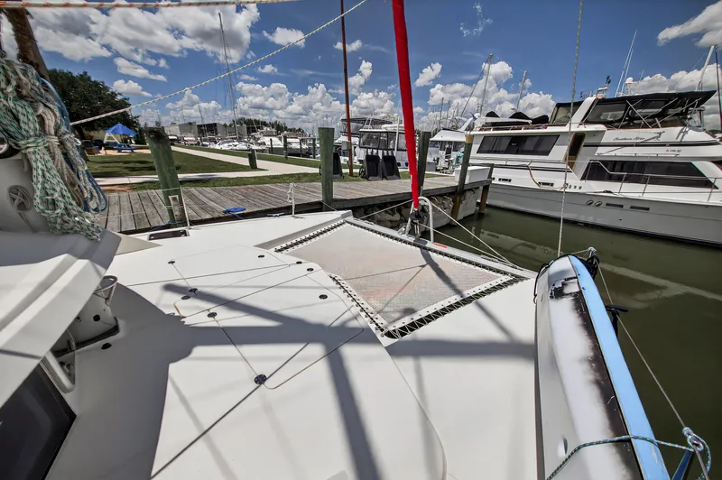 Cocoa Bella Yacht Photos Pics 2011 Leopard 38 catamaran docked at marina, sunny day, clear sky, boats in background.