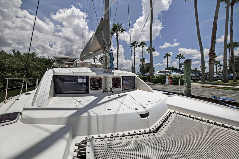 Cocoa Bella Yacht Photos Pics 2011 Leopard 38 catamaran docked under a sunny sky with palm trees.