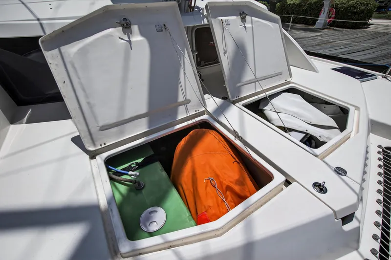 Cocoa Bella Yacht Photos Pics Open storage compartments on a 2011 Leopard 38 catamaran, revealing equipment and an orange bag.