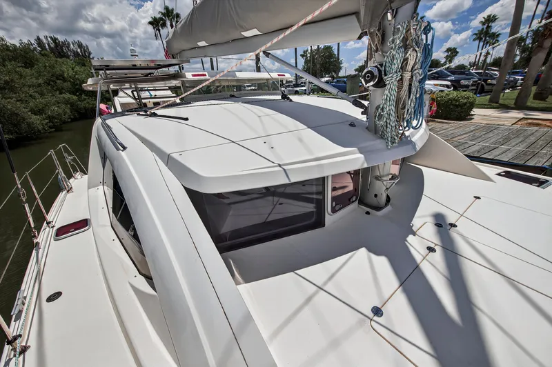 Cocoa Bella Yacht Photos Pics 2011 Leopard 38 catamaran docked, showcasing sleek design and rigging under a sunny sky.