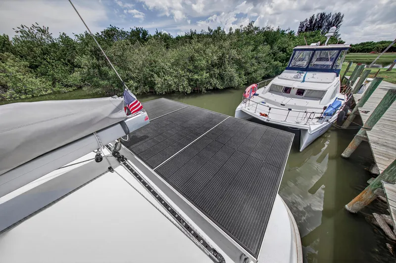 Cocoa Bella Yacht Photos Pics 2011 Leopard 38 catamaran with solar panels docked beside another boat.