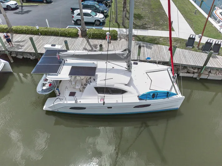 Cocoa Bella Yacht Photos Pics Leopard 38 catamaran docked, featuring solar panels and a kayak, viewed from above.