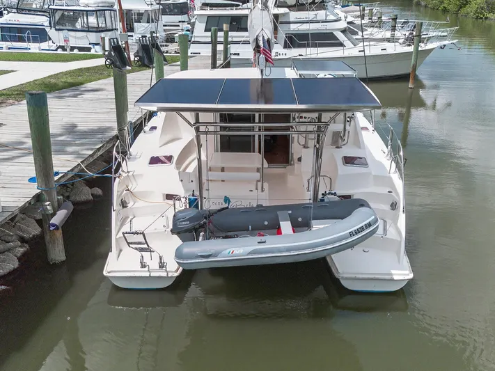 Cocoa Bella Yacht Photos Pics 2011 Leopard 38 catamaran docked with solar panels and inflatable dinghy.