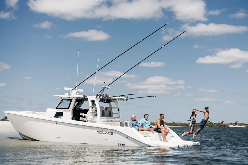 Game Changer Yacht Photos Pics 2022 Solace 415 CS boat with people enjoying water activities under a clear sky.