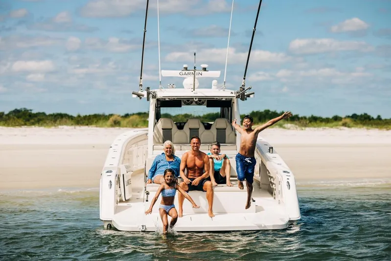 Game Changer Yacht Photos Pics Family enjoying a day on a 2022 Solace 415 CS boat at the beach.