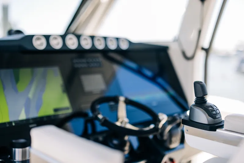 Game Changer Yacht Photos Pics Control panel of 2022 Solace 415 CS boat with steering wheel and joystick.