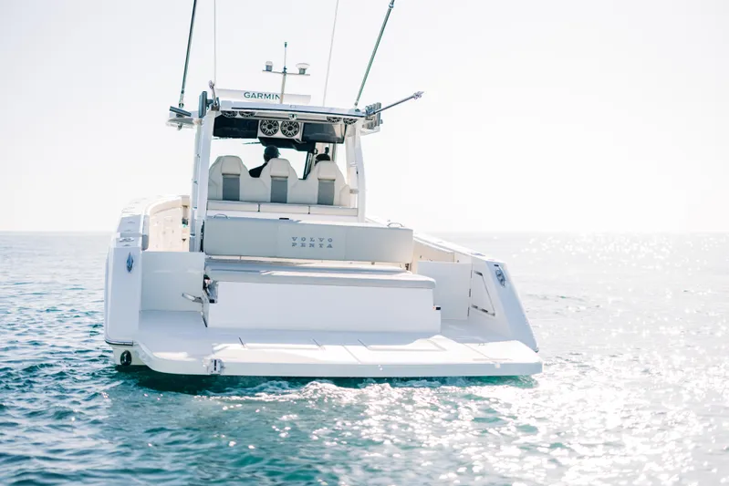 Game Changer Yacht Photos Pics 2022 Solace 415 CS boat on calm ocean waters, rear view.