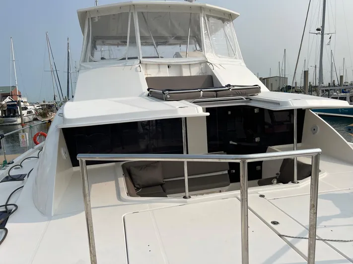 Yacht Photos Pics 2016 Leopard 51 Powercat in harbor, front view with seating area.