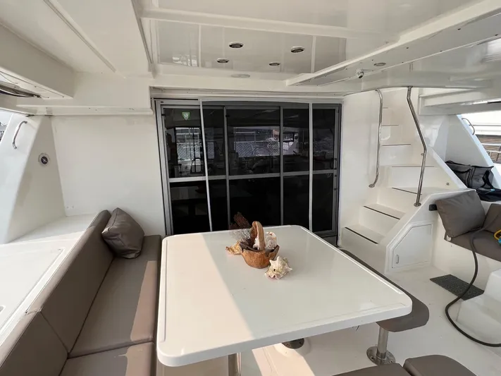  Yacht Photos Pics Interior of a 2016 Leopard 51 Powercat yacht with table and seating area.