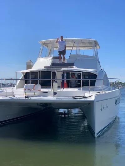  Yacht Photos Pics Leopard 51 Powercat 2016 on calm water with people aboard.