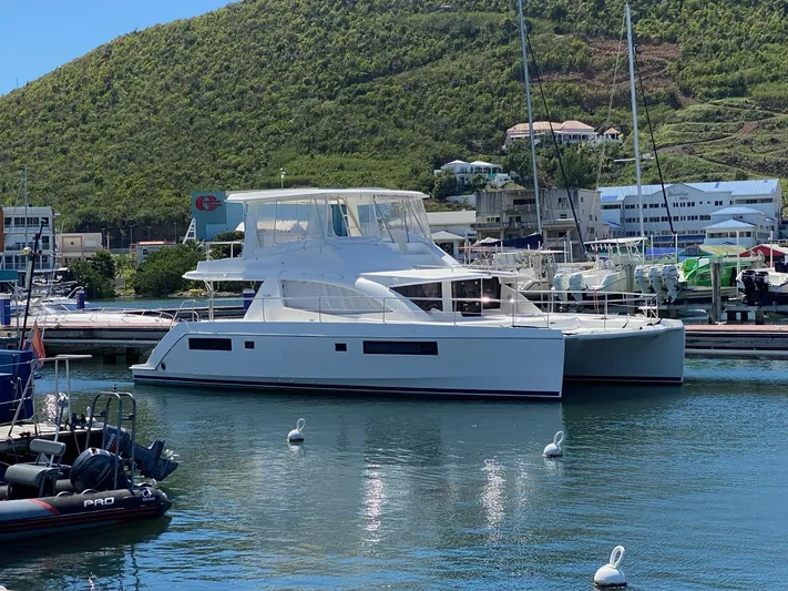  Yacht Photos Pics Leopard 51 Powercat 2016 docked, surrounded by green hills.