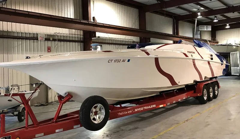  Yacht Photos Pics 1998 Fountain 42 Lightning speedboat on trailer in warehouse setting.