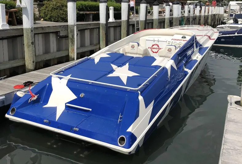  Yacht Photos Pics 1998 Fountain 42 Lightning speedboat with star design docked at marina.