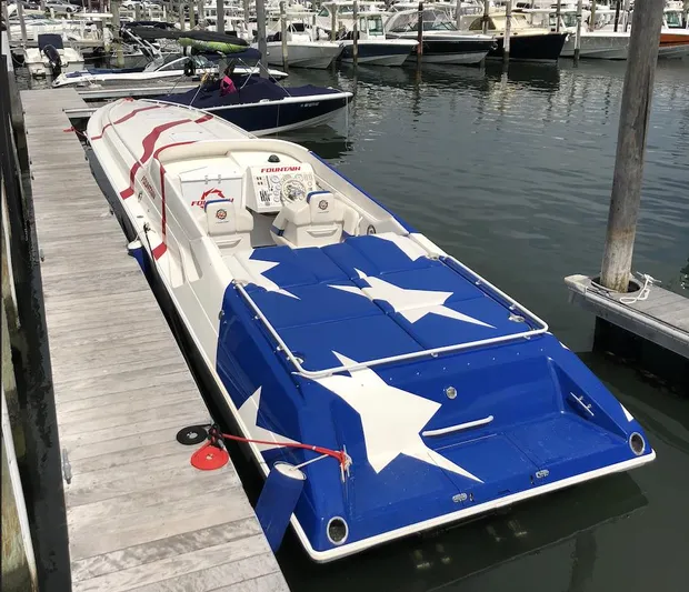  Yacht Photos Pics 1998 Fountain 42 Lightning speedboat with star-spangled design docked at marina.