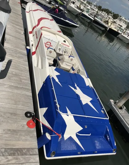  Yacht Photos Pics 1998 Fountain 42 Lightning boat with star-spangled design docked at marina.