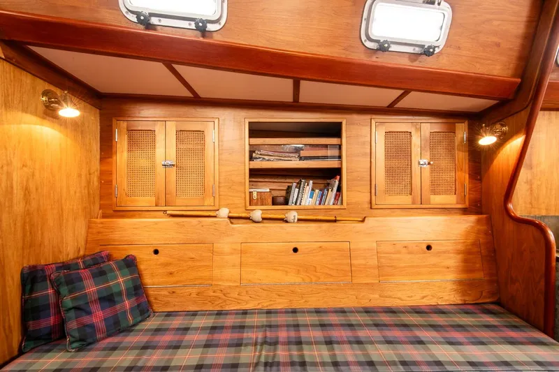 Aleyah Yacht Photos Pics Cozy 1984 Hank Hinckley OC42 yacht interior with wooden cabinets and plaid cushions.