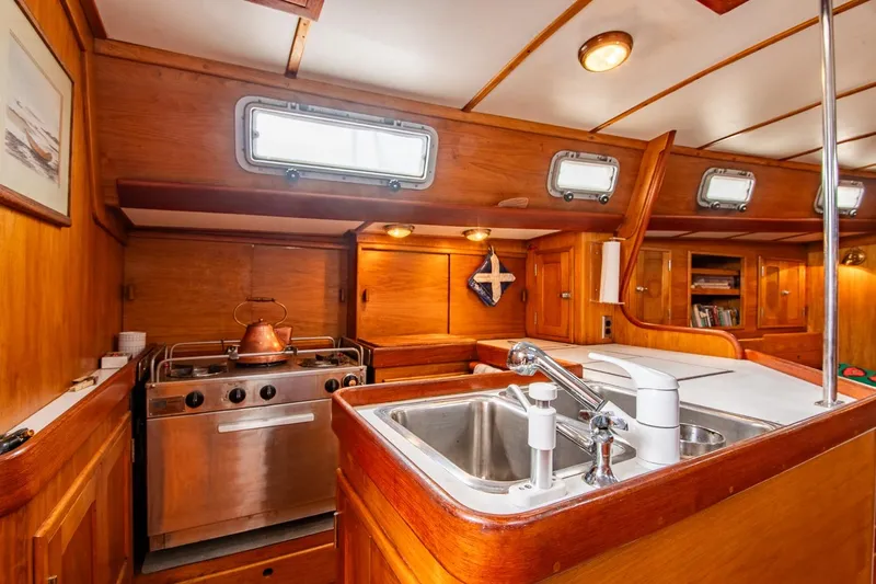 Aleyah Yacht Photos Pics Cozy 1984 Hank Hinckley OC42 yacht kitchen with wood finish and stainless steel appliances.