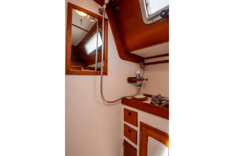 Aleyah Yacht Photos Pics 1984 Hank Hinckley OC42 yacht bathroom with wooden accents and compact design.