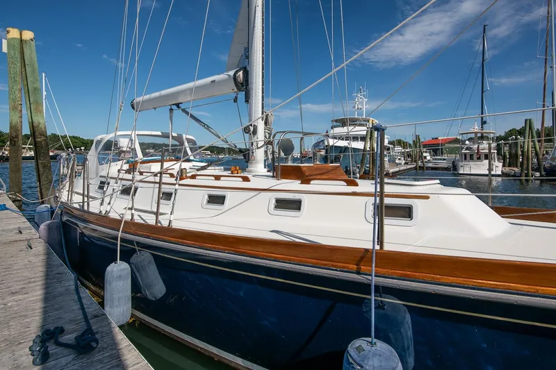 Aleyah Yacht Photos Pics 1984 Hank Hinckley OC42 sailboat docked at marina, clear blue sky, calm waters.