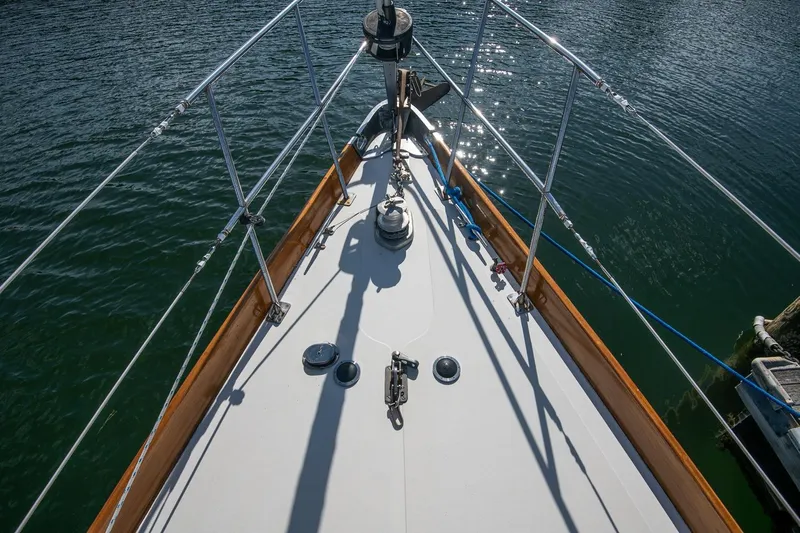 Aleyah Yacht Photos Pics Bow of 1984 Hank Hinckley OC42 sailboat on calm water, showcasing deck details.