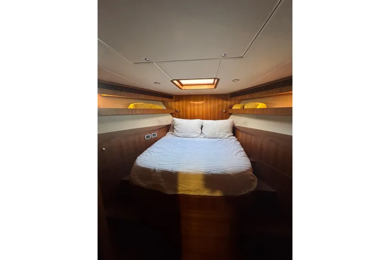 Daddy-o Yacht Photos Pics Luxurious cabin interior of 2023 Outer Reef Yachts 670 Azure Motoryacht, featuring cozy bedding.