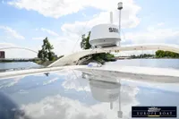 Nimbus 310 Coupe 2000 on a serene river with clear skies and bridge in background.