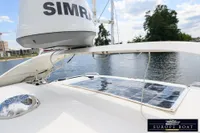 Nimbus 310 Coupe 2000 with solar panel and radar on deck, near water.