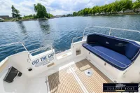 Nimbus 310 Coupe boat deck with seating, overlooking a scenic waterway, 2000 model.