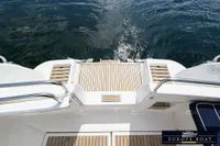 Stern view of 2000 Nimbus 310 Coupe with teak deck and stainless steel railings.