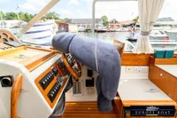 Interior of 2000 Nimbus 310 Coupe boat with covered steering wheel and control panel.