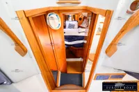 Interior view of 2000 Nimbus 310 Coupe boat cabin with wooden finish.