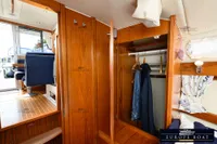 Interior of 2000 Nimbus 310 Coupe with wooden cabinetry and seating area.