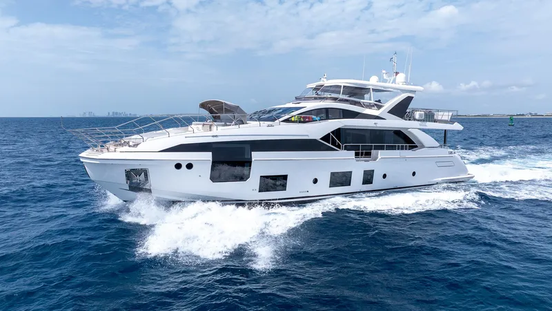 Captain Morgan II Yacht Photos Pics Luxurious 2021 Azimut Grande 27 METRI yacht cruising on open sea under clear skies.