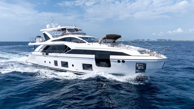 Captain Morgan II Yacht Photos Pics Luxury yacht Azimut Grande 27 METRI 2021 cruising on open sea under blue sky.