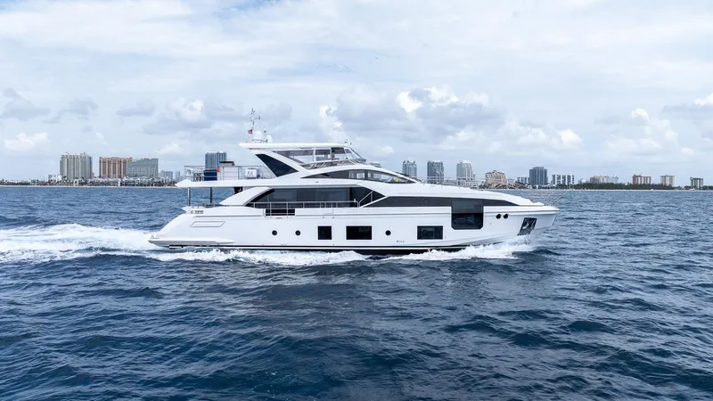 Captain Morgan II Yacht Photos Pics Luxury yacht Azimut Grande 27 METRI cruising near city skyline, 2021 model.