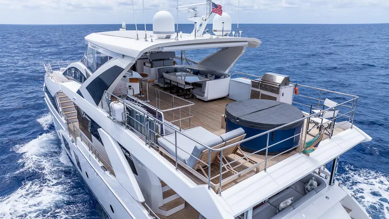Captain Morgan II Yacht Photos Pics Luxurious 2021 Azimut Grande 27 METRI yacht cruising on open sea, featuring spacious deck amenities.