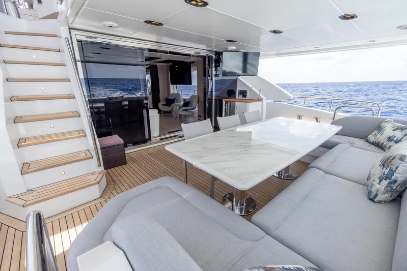 Captain Morgan II Yacht Photos Pics Luxurious Azimut Grande 27 METRI yacht deck with elegant seating and ocean view, 2021 model.