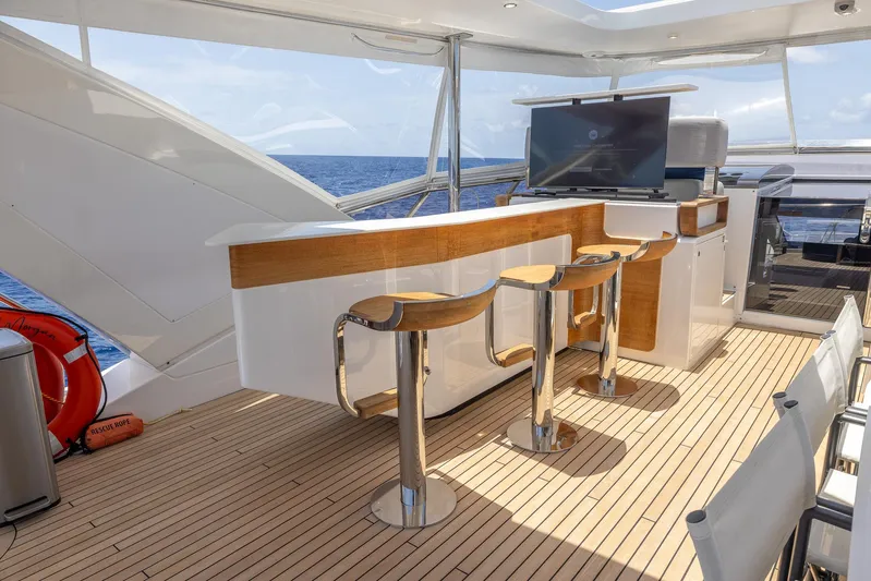 Captain Morgan II Yacht Photos Pics Luxurious Azimut Grande 27 METRI yacht deck with bar stools and ocean view, 2021 model.