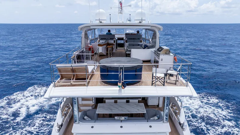 Captain Morgan II Yacht Photos Pics Azimut Grande 27 METRI yacht cruising on open sea, showcasing luxurious deck amenities.