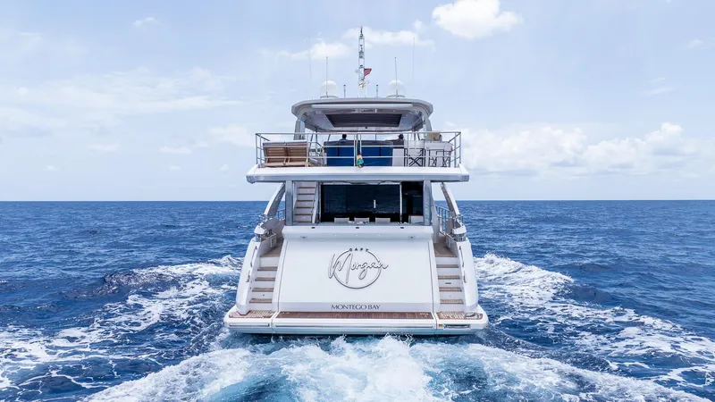 Captain Morgan II Yacht Photos Pics Azimut Grande 27 METRI yacht cruising on open sea, rear view, 2021 model.