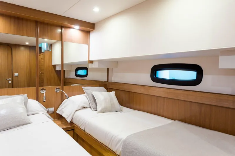 Yacht Photos Pics Luxurious cabin interior of 2026 Sasga Yachts 55, featuring twin beds and elegant wood finishes.