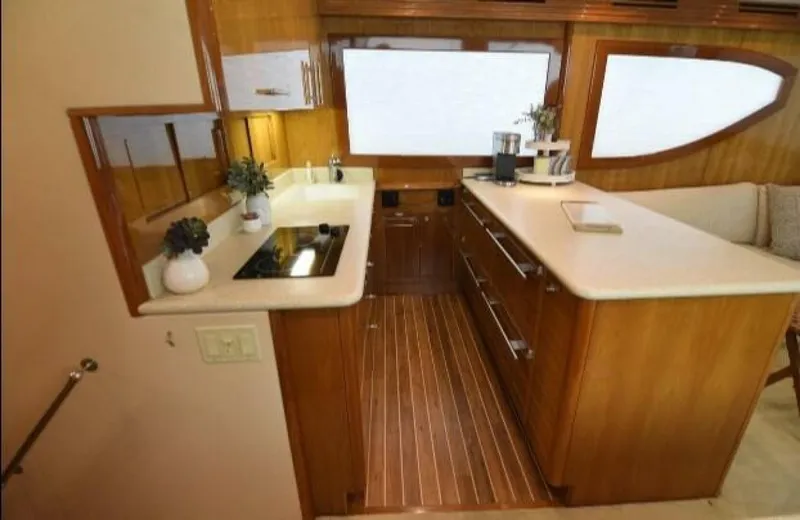 Burnin Daylight Yacht Photos Pics Luxurious kitchen interior of 2006 Hatteras 50 Convertible yacht with modern amenities.