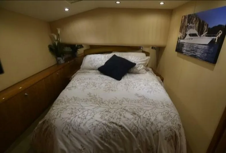 Burnin Daylight Yacht Photos Pics Cozy bedroom in 2006 Hatteras 50 Convertible yacht with elegant decor.
