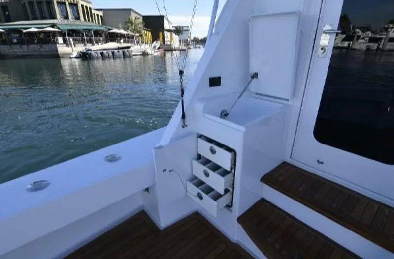 Burnin Daylight Yacht Photos Pics 2006 Hatteras 50 Convertible yacht interior with storage drawers and waterfront view.