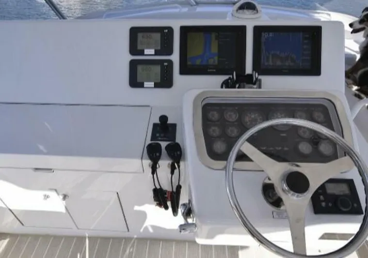 Burnin Daylight Yacht Photos Pics Helm of 2006 Hatteras 50 Convertible yacht with navigation instruments and steering wheel.