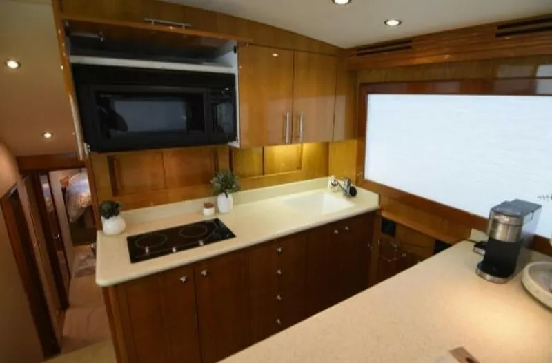 Burnin Daylight Yacht Photos Pics Luxurious kitchen interior of 2006 Hatteras 50 Convertible yacht with modern appliances.