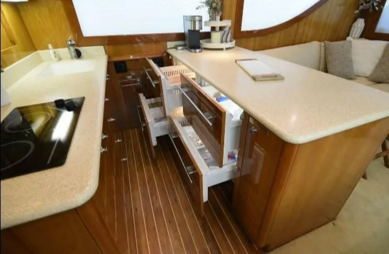 Burnin Daylight Yacht Photos Pics Luxurious kitchen interior of 2006 Hatteras 50 Convertible yacht with open drawers.