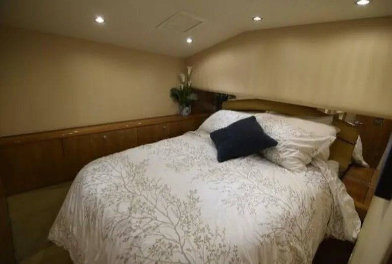 Burnin Daylight Yacht Photos Pics Luxurious bedroom interior of 2006 Hatteras 50 Convertible yacht with elegant bedding.