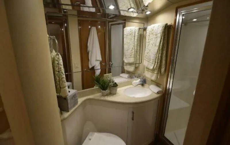 Burnin Daylight Yacht Photos Pics Luxurious bathroom in 2006 Hatteras 50 Convertible yacht, featuring elegant fixtures and decor.